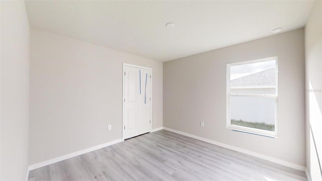 spare room featuring light hardwood / wood-style flooring