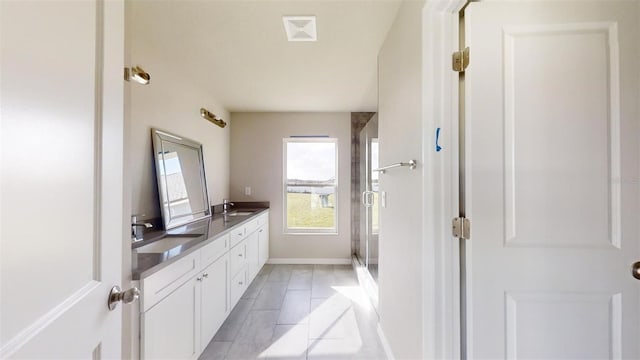 bathroom featuring tile patterned floors, vanity, and an enclosed shower