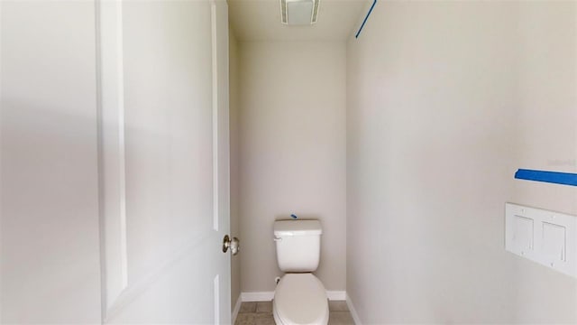 bathroom featuring toilet and tile patterned floors