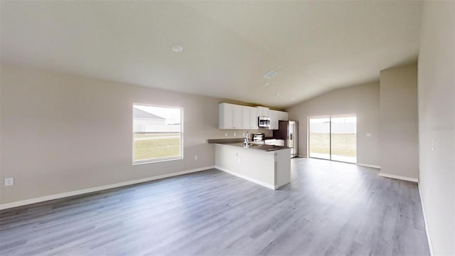 kitchen featuring light hardwood / wood-style floors, white cabinetry, kitchen peninsula, and appliances with stainless steel finishes