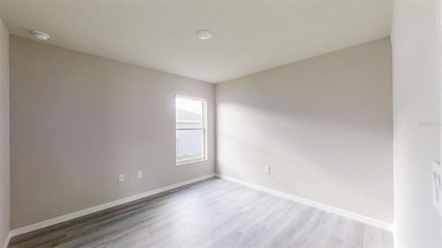 unfurnished room with light wood-type flooring