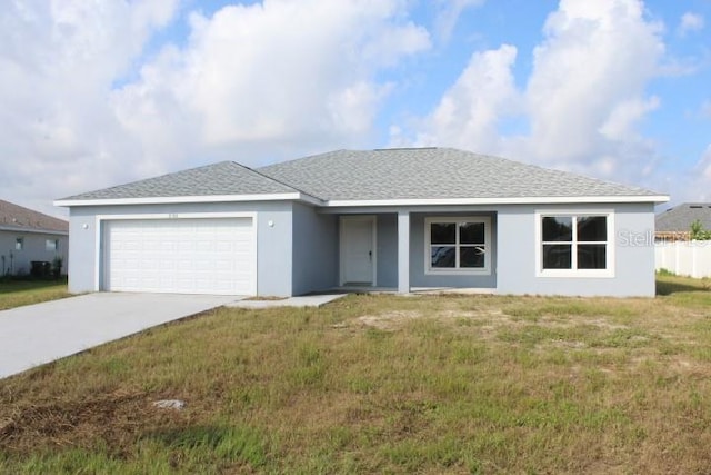 ranch-style home featuring a garage and a front yard