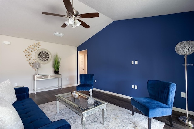 living room featuring ceiling fan, dark hardwood / wood-style flooring, and vaulted ceiling