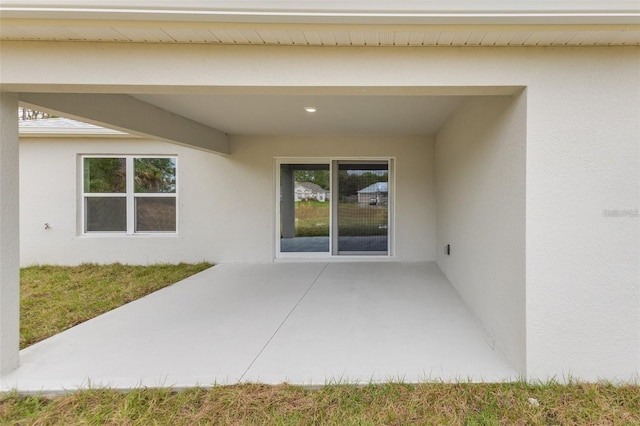 property entrance featuring a patio