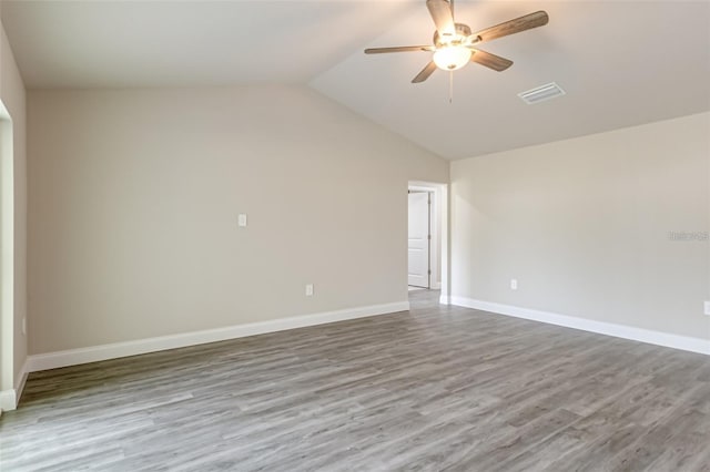 spare room with ceiling fan, high vaulted ceiling, and wood-type flooring