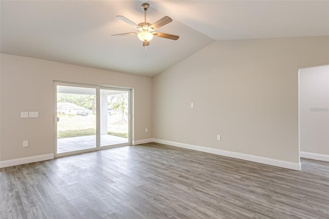 empty room featuring ceiling fan, lofted ceiling, and wood-type flooring