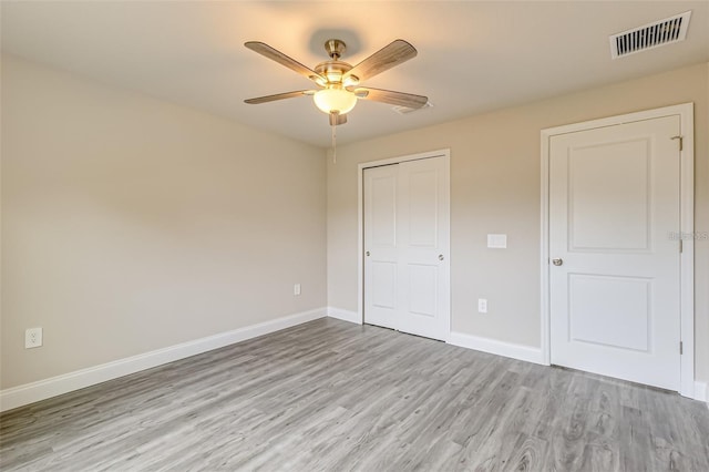 unfurnished bedroom featuring ceiling fan, light hardwood / wood-style flooring, and a closet