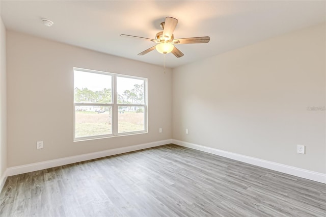 empty room featuring ceiling fan and hardwood / wood-style flooring