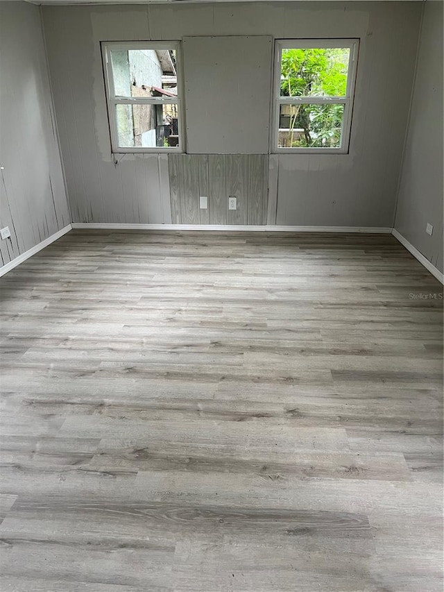 empty room with a healthy amount of sunlight and light wood-type flooring