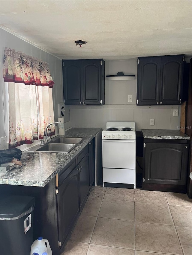 kitchen featuring white range oven and sink