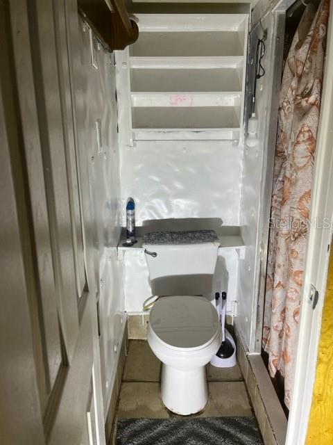 bathroom with tile patterned flooring and toilet