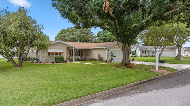 ranch-style house with a garage and a front yard