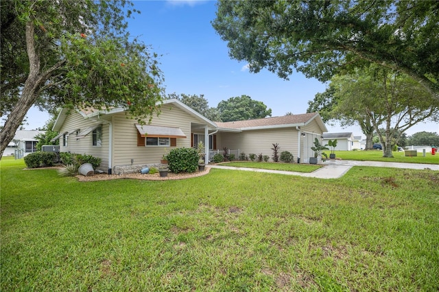 ranch-style home with a garage and a front yard