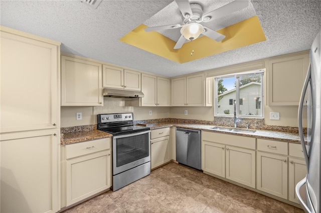 kitchen with appliances with stainless steel finishes, ceiling fan, cream cabinetry, and sink