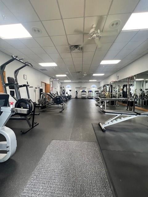 gym with a paneled ceiling