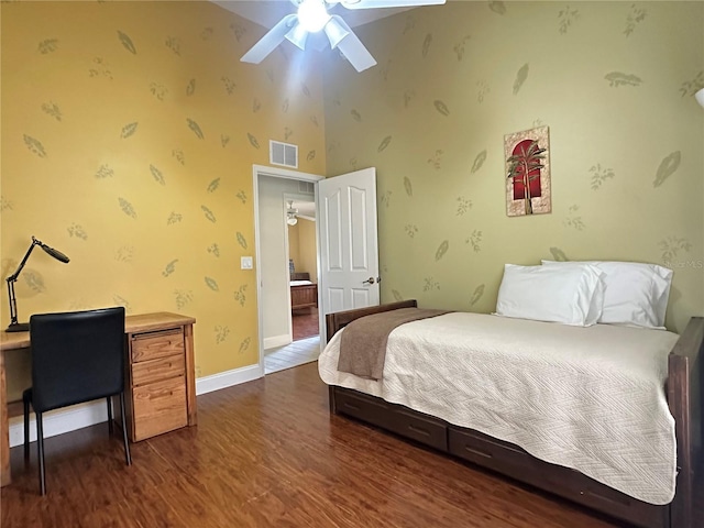 bedroom featuring a high ceiling, dark hardwood / wood-style floors, and ceiling fan