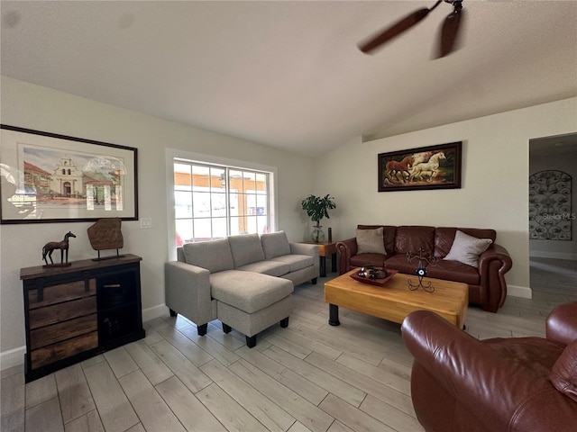 living room featuring ceiling fan, vaulted ceiling, and light wood-type flooring