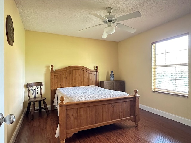 bedroom with multiple windows, ceiling fan, and dark wood-type flooring