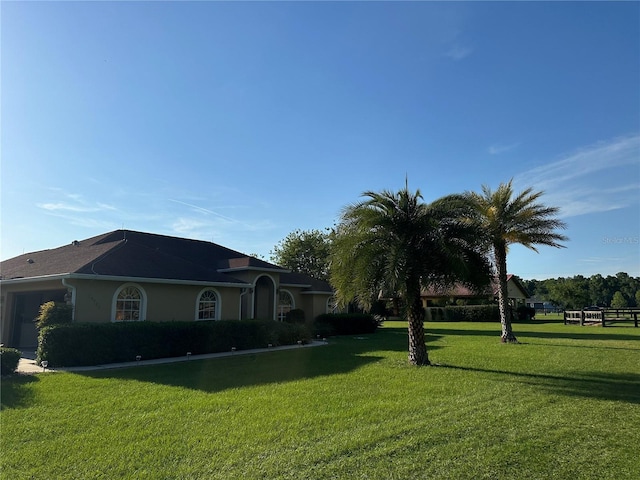 view of front of house with a garage and a front lawn