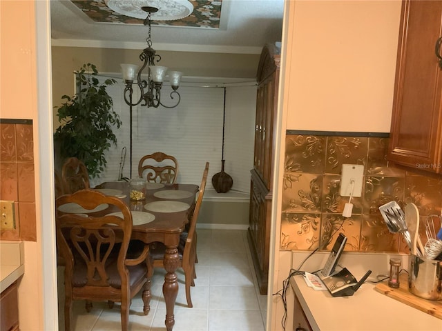 dining area featuring light tile patterned flooring, crown molding, a textured ceiling, and an inviting chandelier