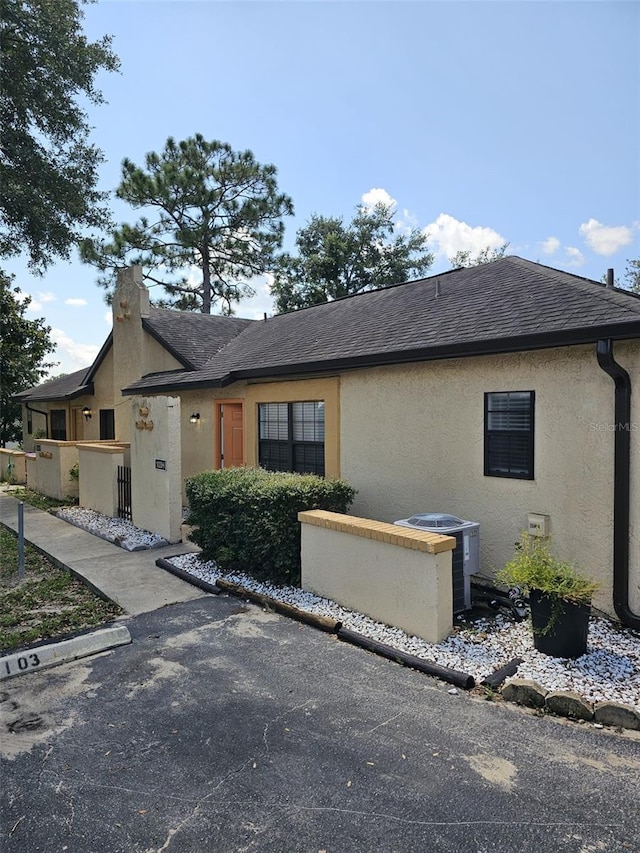 ranch-style house with central AC unit