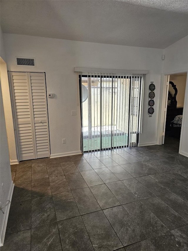 spare room with a textured ceiling