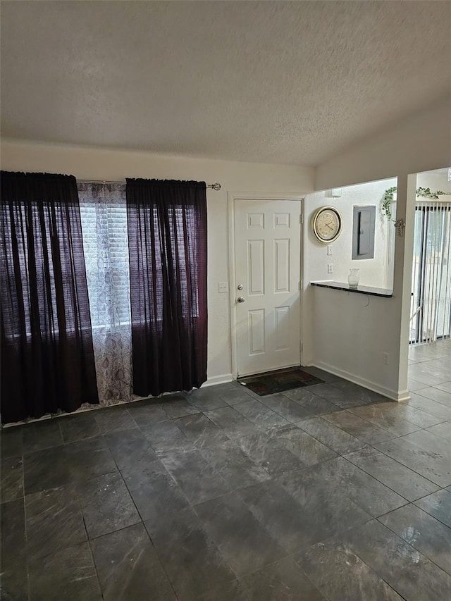 foyer entrance featuring a textured ceiling