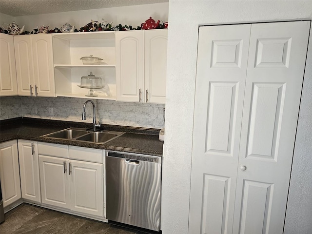 kitchen featuring a textured ceiling, tasteful backsplash, sink, white cabinetry, and stainless steel dishwasher