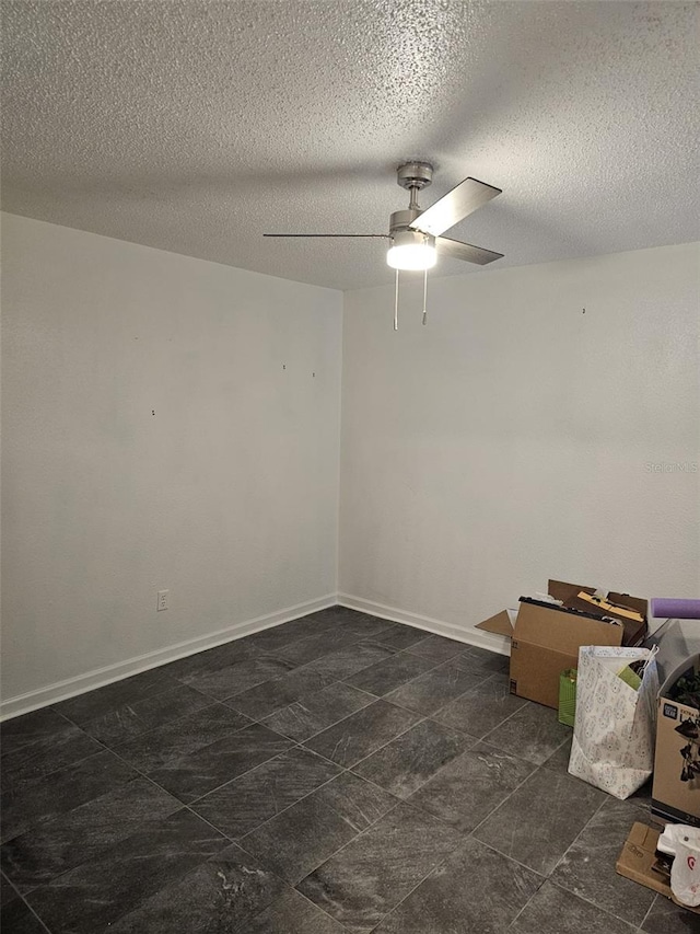 spare room with ceiling fan and a textured ceiling