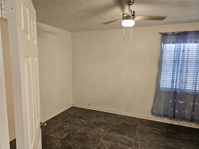 spare room featuring ceiling fan and a textured ceiling