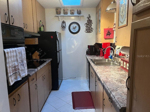 kitchen featuring sink, black appliances, light tile patterned flooring, and light stone countertops