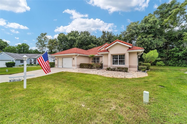 view of front of house with a garage and a front lawn