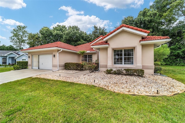 mediterranean / spanish home with a front yard and a garage