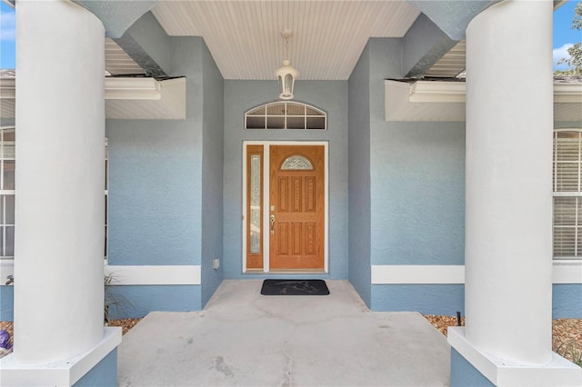 doorway to property with stucco siding