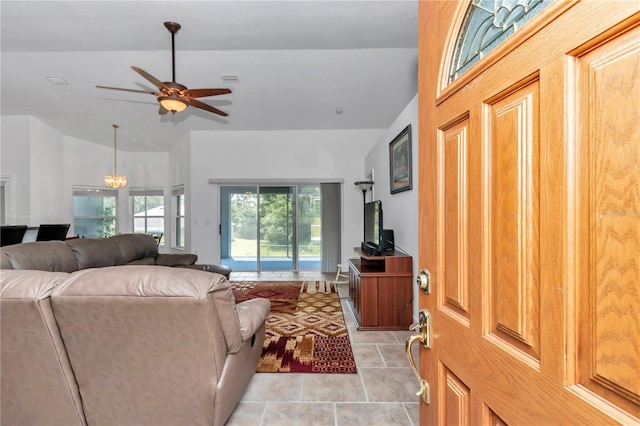 living room featuring lofted ceiling, visible vents, and a ceiling fan