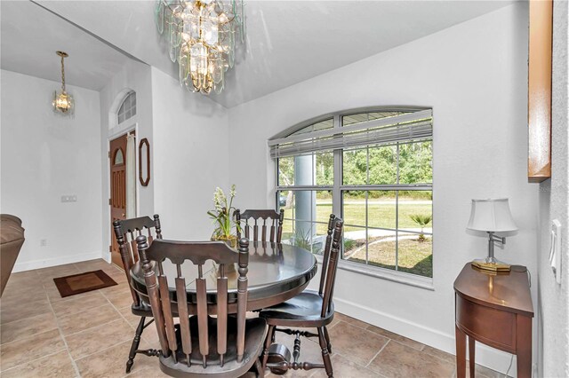 tiled dining space featuring a chandelier