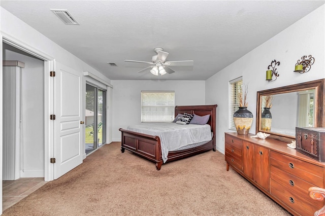 bedroom featuring light carpet, visible vents, and access to exterior