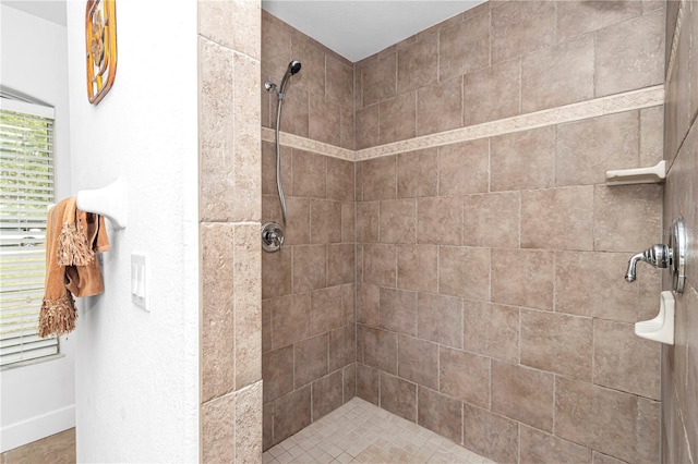 full bath featuring tiled shower