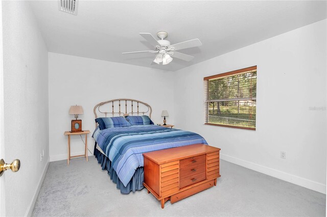 bedroom with carpet floors, visible vents, baseboards, and a ceiling fan