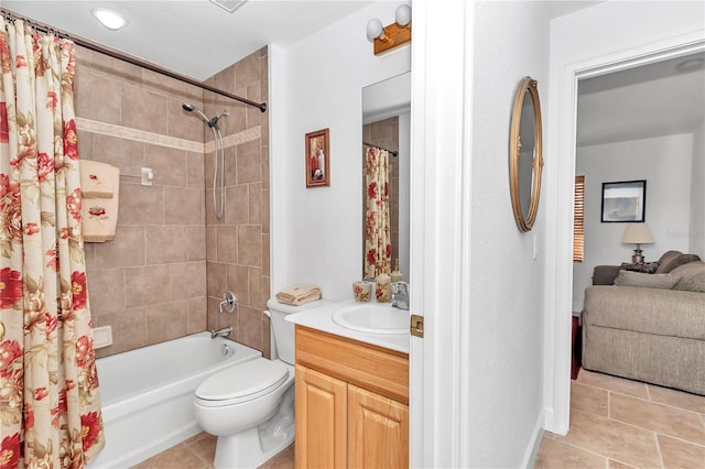 full bath with shower / bath combo, vanity, toilet, and tile patterned floors