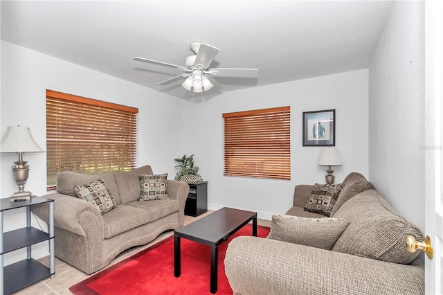 living area featuring ceiling fan and baseboards