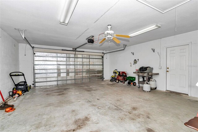 garage with ceiling fan and a garage door opener