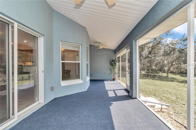 unfurnished sunroom featuring ceiling fan and lofted ceiling