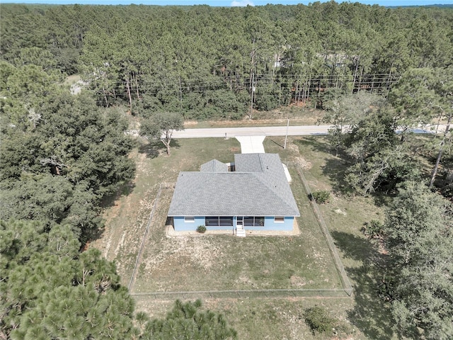 birds eye view of property featuring a wooded view