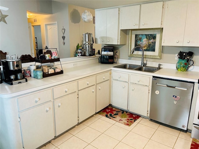 kitchen featuring dishwasher, sink, and light tile patterned flooring