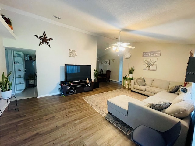 living room with hardwood / wood-style floors, ceiling fan, and vaulted ceiling