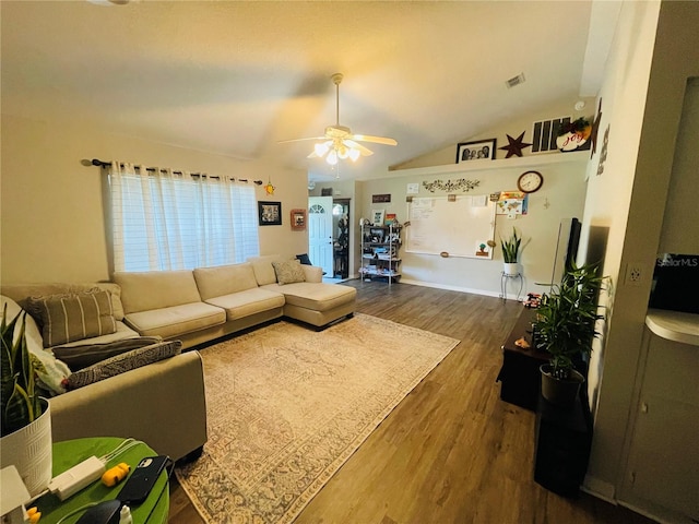 living room featuring dark wood-type flooring, lofted ceiling, and ceiling fan