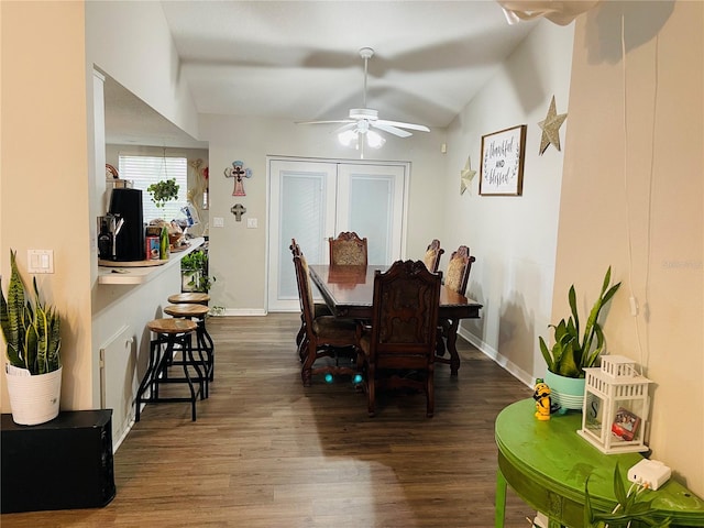 dining room featuring vaulted ceiling, hardwood / wood-style flooring, and ceiling fan