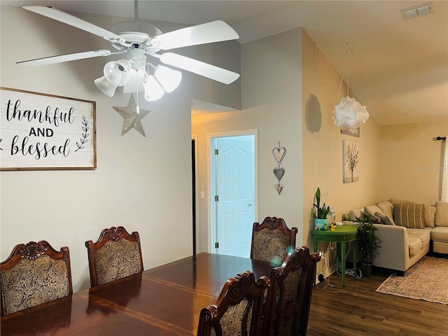 dining area featuring ceiling fan, dark hardwood / wood-style flooring, and vaulted ceiling