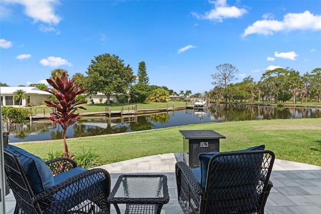 view of patio with a boat dock and a water view